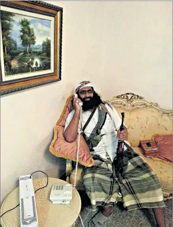  ??  ?? Khaled Batarfi, an AQAP commander, holds court in a provincial governor’s palace after he was freed from prison by his forces