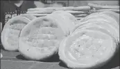  ??  ?? In the Afghan settlement in Bhogal in south Delhi, delicious breads emerge from tandoors that look like pizza ovens, with the breads stuck on the outer walls.