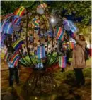  ?? JAMES HILL/THE NEW YORK TIMES ?? Josée Grard (right) examined lanterns placed on a memorial dedicated to the victims of colonial slavery near the Basilica of St. Denis in Paris in November.