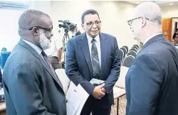  ??  ?? Dr Eric Deans (left), chief executive officer of the Jamaica Special Economic Zone Authority, and Kirk Philips (centre), deputy director general of the Planning Institute of Jamaica, have a candid conversati­on with Dr Paul Kent, senior vice-president...