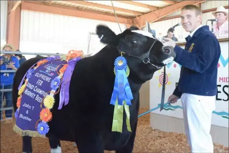  ??  ?? John Cummings of Brawley FFA and his steer Buster were named the Supreme Champion earlier in the week during the California Mid-Winter Fair & Fiesta in Imperial. Buster sold for $12 a pound at the livestock auction Saturday. MARIO RENTERIA PHOTO