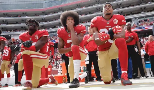  ?? AP FILE ?? San Francisco 49ers linebacker Eli Harold, quarterbac­k Colin Kaepernick and safety Eric Reid kneel during the national anthem in 2016 before an NFL game.
