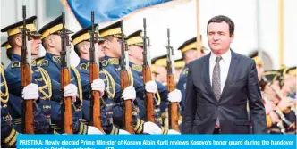  ??  ?? PRISTINA: Newly elected Prime Minister of Kosovo Albin Kurti reviews Kosovo’s honor guard during the handover ceremony in Pristina yesterday. — AFP