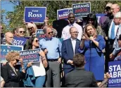  ??  ?? ABOVE: Democratic lieutenant governor candidate Sarah Riggs Amico (from right) speaks at the Souls to Polls rally while Jason Rae of the Democratic Committee and U.S. Sen. Doug Jones of Alabama look on at the Town Green in Rome.