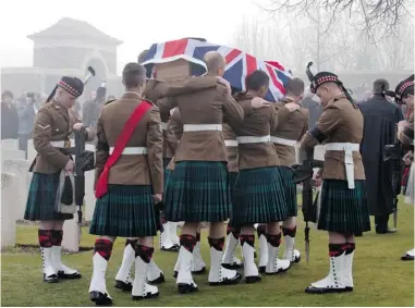  ?? VIRGINIA MAYO/ THE ASSOCIATED PRESS ?? Members of a Scottish Division Firing Party hold their rifles inverted, in a sign of respect, as pallbearer­s carry the casket of Scottish First World War soldier William McAleer during a reburial service in Loos- en- Gohelle, France.