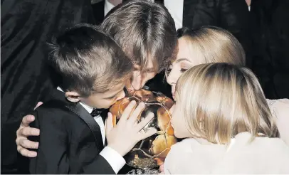  ?? Picture: Reuters ?? FAMILY AFFAIR. Ballon d’Or winner Luka Modric (centre), his wife Vanja, his son Ivano and his daughter Ema kiss the trophy the Croatian lifted in Paris on Monday night.