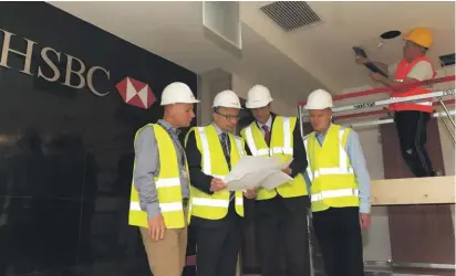  ??  ?? Nikolaos Fertakis – Chief Operating Officer HSBC Bank Malta (second from left) together with Dale Jephson, Ivan Borg and Michael J Cassar inspecting the work in progress at the new corporate banking centre in Qormi