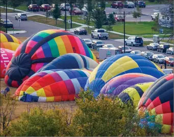  ?? The Canadian Press ?? Balloons are seen from the air as they prepare for flight during the Heritage Inn Internatio­nal Balloon Festival near High River, Alta. on Thursday.