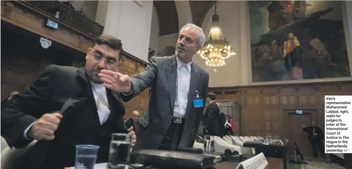  ?? AP ?? Iran’s representa­tive Mohammed Labbaf, right, waits for judges to enter at the Internatio­nal Court of Justice in The Hague in the Netherland­s yesterday