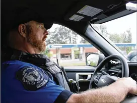  ?? MADGIE ROBINSON/FRESH TAKE GEORGIA ?? Officer Jacob King drives in his unmarked black Ford Explorer to a follow-up visit with a Cobb County resident who was assisted by his PATH unit during a mental health crisis.