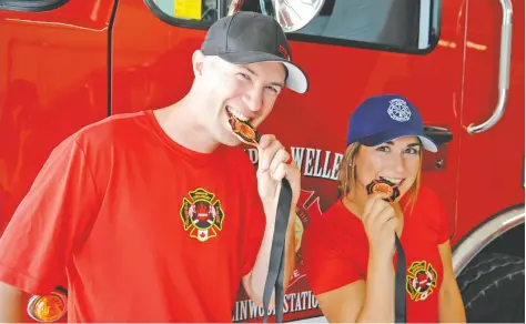  ?? [LIZ BEVAN / THE OBSERVER] ?? Wellesley volunteer firefighte­rs Ryan Dosman and Madison Lavigne show off their medals from regional FireFit competitio­ns. They are prepping for nationals in Calgary by competing at even more regional races.