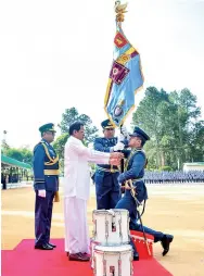  ??  ?? CTS Diyatalawa Commanding Officer Air Commodore Peterson Fernando receiving the President’s Colours from President Maithripal­a Sirisena