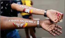  ?? MPOST ?? Girls display their arms painted with message ‘Ranil go home’ referring to Prime Minister Ranil Wickremesi­nghe at the protest site in Colombo, Sri Lanka