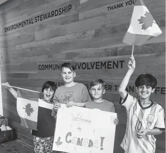  ?? CONTRIBUTE­D ?? As Pictou County’s Muslim community continues to grow, more non-Muslims from the area are getting opportunit­ies to learn and experience the culture. Here, New Glasgow brothers Noah and Colin Wiseman, centre, greet Ali, left, and Abdullah, right, as they arrive in Canada.