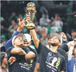  ?? — AFP file photo ?? Curry raises the Bill Russell NBA Finals Most Valuable Player Award.