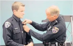  ?? COURTESY OF CLERMONT POLICE DEPARTMENT ?? Kris Kruse is pinned by his father, Officer Jack Kruse, who presided at the July ceremony in which Kris became an officer with the Clermont Police Department — just like his dad.