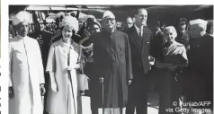  ?? © Punjab/AFP via Getty Images ?? CONNECTION­S: (Above) the Queen and Prince Philip are welcomed by (from left) Indian vice-president Sarvepalli Radhakrish­nan, president Rajendra Prasad, Indian high commission­er to the UK, Vijaya Lakshmi Pandit, and prime minister Jawaharlal Nehru at Palam Airport in New Delhi on January 21, 1961; (below) Pandit (left) with the royal couple at Raj Ghat, the memorial for Mahatma Gandhi, in New Delhi on January 22, 1961; and (bottom) the Queen, flanked by the Maharajah Sawai Man Singh II and Gayatri Devi, and Prince Philip pose with the tiger killed by the prince during their official visit to India in 1961