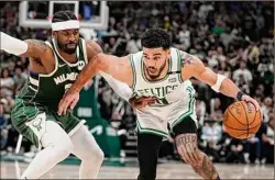  ?? Morry Gash / Associated Press ?? Boston Celtics’ Jayson Tatum tries to get past Milwaukee Bucks’ Wesley Matthews during the second half of Game 6 of an NBA Eastern Conference semifinals playoff series Friday in Milwaukee. Tatum scored 46 points to help lead the Celtics to a 108-95 victory to tie the
series at 3-3.