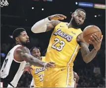  ?? Ringo H.W. Chiu Associated Press ?? CLIPPERS’ Paul George, left, will now have to contend with the unexpected return of Lakers’ LeBron James in rivalry game.
