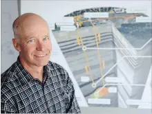  ?? JEFF MCINTOSH THE CANADIAN PRESS ?? Enhance Energy CEO Kevin Jabusch's company has signed a deal to work on the Alberta Carbon Trunk Line project designed to capture CO2. He is seen with a diagram of the project at his office in Calgary, Alta., Aug. 23.