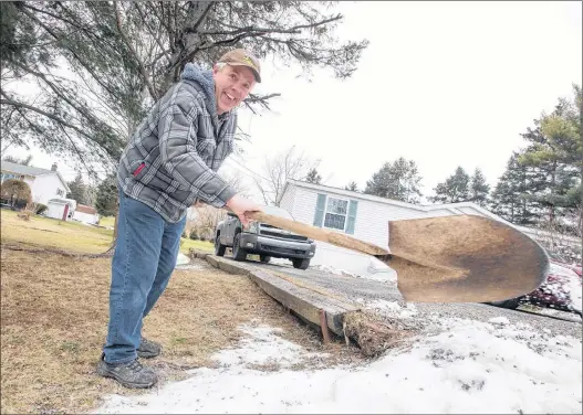  ?? MARK GOUDGE/ SALTWIRE NETWORK ?? Dave Sexton, of Falmouth, clears away snow from the edge of his driveway and gutter in preparatio­n for a large snowstorm that was due to hit Nova Scotia Jan. 30-31.