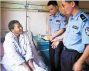  ??  ?? Two police officers from Fengxian’s entry-exit administra­tion office visit the Tanzanian woman in hospital. — Ti Gong