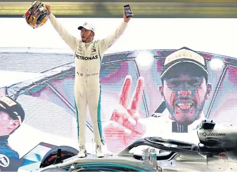  ?? Picture: Getty Images. ?? Lewis Hamilton celebrates after winning his fifth Formula One World Championsh­ip.