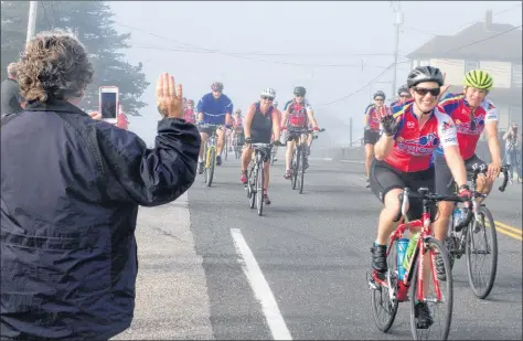  ??  ?? Waves from spectators and participan­ts during the 2017 Gran Fondo Baie Sainte-Marie cycling event.