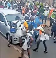  ?? ?? KZN VIP Protection Services in Phoenix shared videos of some of the chaos recorded in Woodview, Grove-End and Shastri Park on its Facebook page. Above are screenshot­s from a video taken near a Phoenix school. From left: A pupil stops a car in the street; more pupils join in; and a group jumps on the car, with some pupils posing for the camera.