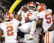  ?? STEVE HELBER — THE ASSOCIATED PRESS ?? Clemson linebacker Dorian O’Daniel (6) celebrates with his teammates after a pick six during the second half of an NCAA college football game in Blacksburg, Va., Saturday. Clemson won the game 31-17.