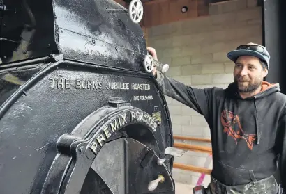  ?? PHOTO: GREGOR RICHARDSON ?? Home sweet home . . . Thomas Gregg Apartments developmen­t foreman Ryan Muir reinstalls the original 1915 Jabez Burns coffee roaster that once operated at the Gregg’s Coffee Factory in Fryatt St.