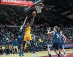  ?? FRED GOODE — FOR THE TRENTONIAN ?? Nottingham’s Darell Johnson (5) lays in two of his 20 points against Chatham in the Group III state final at Rutgers on Sunday night.