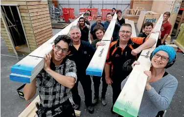  ?? MARTIN DE RUYTER/NELSON MAIL ?? NMIT students and tutors Richard Shepard, second from left, Andy Waugh, sixth from left and Murray Leaning, Mitre 10 Mega with Nelson Pine Industries LVL timber that will be used in sub-floor constructi­on of the Helicopter House Build project.