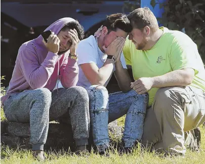  ?? AP PHOTOS ?? ANOTHER SHOOTING: Workers from the Advanced Granite Solutions company console each other as police and other first responders investigat­e a shooting at a business park in the Edgewood area of Harford County, Md., yesterday.