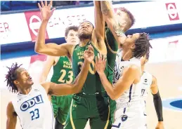  ?? MIKE CAUDILL/FREELANCE ?? William & Mary and Old Dominion players fight for a rebound during the first half of the Monarchs’ 86-78 victory Saturday night at Chartway Arena. It was the last game the Tribe will play for at least two weeks.