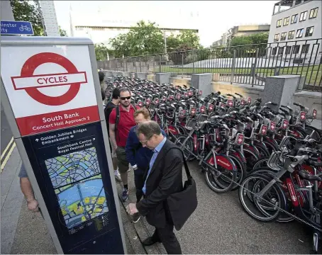  ??  ?? Desperate measure: People queueing up to hire cycles from a city bike-sharing scheme during a 24-hour london undergroun­d train strike.