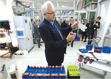  ??  ?? PRAGUE: Company HE3DA President Jan Prochazka shows qualities of a new battery during the official start of a battery production line. — AP