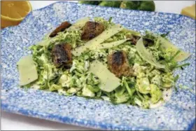  ?? MELISSA D’ARABIAN VIA AP ?? Shown is a dish of Brussels sprouts Caesar salad with sardine croutons in Bethesda, Md. A fresh and healthy spin on a Caesar salad using Brussels sprouts instead of romaine, a little mayo instead of raw egg, sardines as croutons and no anchovy paste.