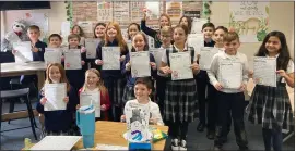  ?? GINA JOSEPH — MEDIANEWS GROUP ?? Students in Andrea Korotko’s fourth-grade class at St. Mary’s Catholic School in Mount Clemens joyfully display their letters to Santa.