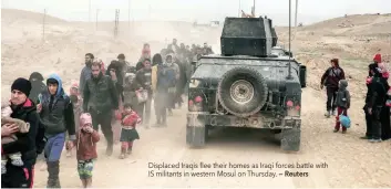  ?? — Reuters ?? Displaced Iraqis flee their homes as Iraqi forces battle with IS militants in western Mosul on Thursday.