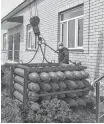  ?? REUTERS ?? Workers unload oxygen balloons, which are used for treating COVID-AND pneumonia patients, outside a local hospital in Dagestan’s Gurbuki village, Russia, in this undated handout picture.