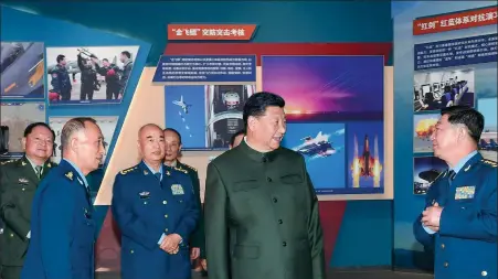  ?? LI GANG / XINHUA ?? Central Military Commission Chairman Xi Jinping, who is also president of China and the general secretary of the Communist Party of China Central Committee, visits an exhibition marking the 70th anniversar­y of the founding of the PLA Air Force on Friday.