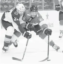  ?? WILFREDO LEE/AP ?? Avalanche center Colin Wilson (22) and Panthers center Colton Sceviour battle for control of the puck during the first period Friday night in Sunrise.