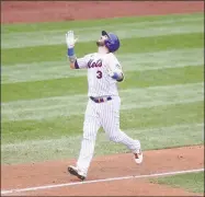  ?? Al Bello / TNS ?? The Mets’ Tomas Nido rounds the bases after hitting a fifth-inning grand slam against the Nationals’ Seth Romero on Thursday.