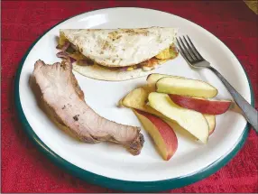  ?? (NWA Democrat-Gazette/Flip Putthoff) ?? A breakfast taco, apple slices and a leftover barbecue rib will fortify any angler for day out fishing.