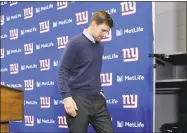  ?? Bill Kostroun / Associated Press ?? Giants quarterbac­k Eli Manning walks off the dais after a news conference on Sunday.