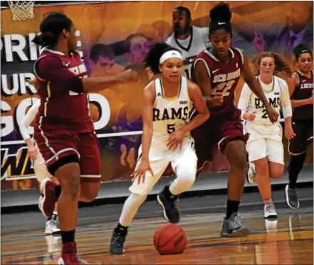  ?? ANNE NEBORAK — DIGITAL FIRST MEDIA ?? West Chester guard Porscha Speller heads up court between two Lock Haven defenders during Saturday’s PSAC women’s basketball contest.