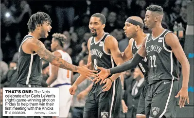  ?? Anthony J. Causi ?? THAT’S ONE: The Nets celebrate after Caris LeVert’s (right) game-winning shot on Friday to help them win their first meeting with the Knicks this season.