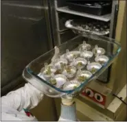  ?? ED ANDRIESKI — THE ASSOCIATED PRESS FILE ?? In this Friday file photo, samples of marijuana are tested in an oven at Full Spectrum Laboratori­es in Denver. Ohio’s regulation­s for prospectiv­e medical marijuana cultivator­s were finalized Monday and applicatio­n forms were released Friday including a...