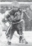  ?? PAUL W. GILLESPIE/BALTIMORE SUN MEDIA GROUP ?? Navy quarterbac­k Malcolm Perry picks up a first down in the fourth quarter. In his second start at quarterbac­k, the sophomore rushed for 250 yards and a touchdown.